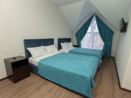 Family suite with two large beds and a sofa